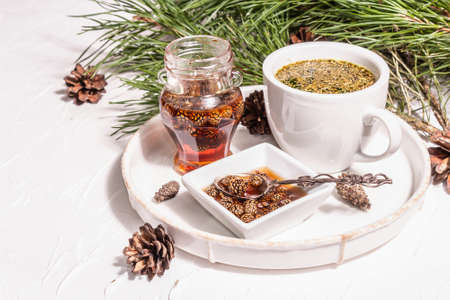 Pine needle tea, sollip-cha, traditional Korean beverage. Pine cone jam, alternative medicine, healthy life style. White putty background, copy spaceの写真素材