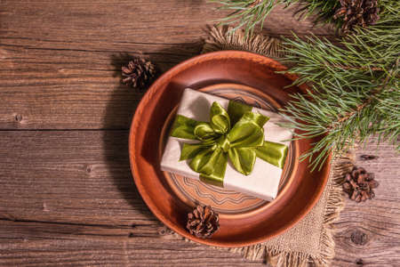 Christmas festive table setting. New Year zero waste gift concept. Trendy hard light, dark shadow. Vintage wooden table, top viewの写真素材