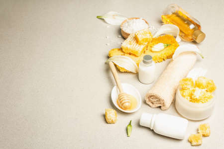Spa concept. Self care with honey, sea salt, and cream. Natural organic cosmetics, homemade products, alternative lifestyle. Light stone background, copy spaceの写真素材