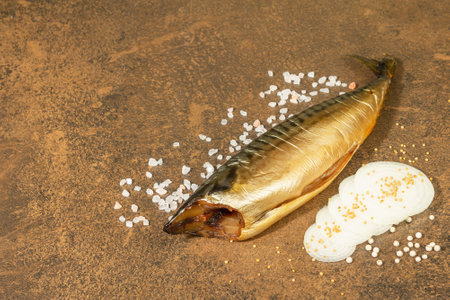Cold smoked mackerel on stone background. Onion slices, sea salt and dijon mustardの写真素材