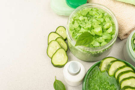Homemade cosmetics with cucumber. Detoxification skin vegetable masks. Natural cream, sea salt, body lotion, and soap. Light stone concrete background, copy spaceの写真素材
