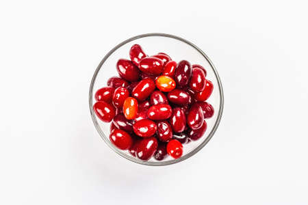 Dogwood berry isolated on a white background. Ripe red Cornus in a bowl, flat lay, template, mockupの写真素材