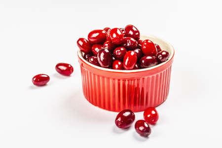 Dogwood berry isolated on a white background. Ripe red Cornus in a bowl, flat lay, template, mockupの写真素材