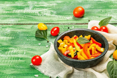 Seasonal fresh vegetable salad. Ripe tomatoes, cucumbers, bell peppers, basil leaves and spices....