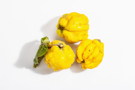 Ripe whole quince isolated on white background. Fresh fruit, an essential ingredient for a healthy...