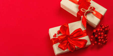 Gift concept in red colors. New Year or Christmas, festive mood. Wrapped boxes, minimal design, red...
