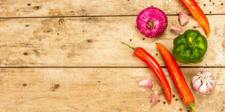 Cooking background. Set of fresh vegetables on wooden boards table. Collection of colorful products, flat lay, banner formatの写真素材