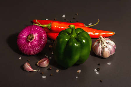 Cooking background. Set of fresh vegetables on black stone background. Collection of colorful...