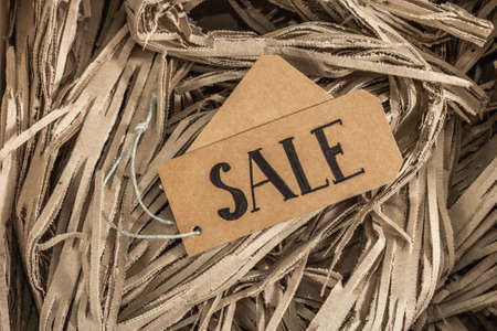 Black Friday. Sale tag on the paper filler. Zero waste shopping concept, flat lay, top viewの写真素材