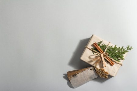 Zero waste gift concept. Christmas or New Year eco-friendly packaging. Festive boxes in craft paper with different organic decorations. Trendy hard light, dark shadow, flat lay, top viewの写真素材