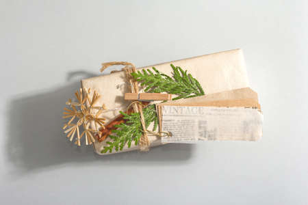 Zero waste gift concept. Christmas or New Year eco-friendly packaging. Festive boxes in craft paper with different organic decorations. Trendy hard light, dark shadow, flat lay, top viewの写真素材