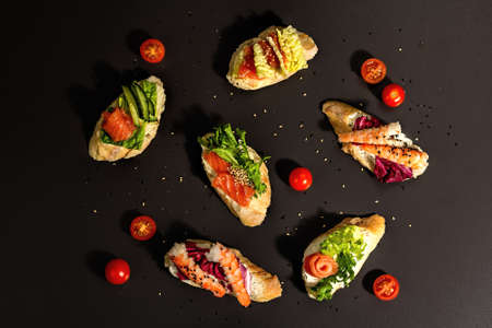 Assorted open sandwiches with salted salmon, shrimps, cream cheese, salad leaves and cucumber....