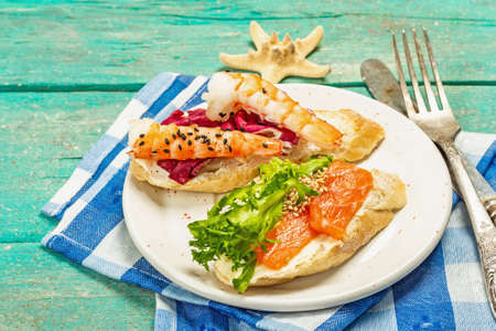 Open sandwiches with salted salmon, cream cheese, salad leaves and cucumber. Seafood, healthy food....