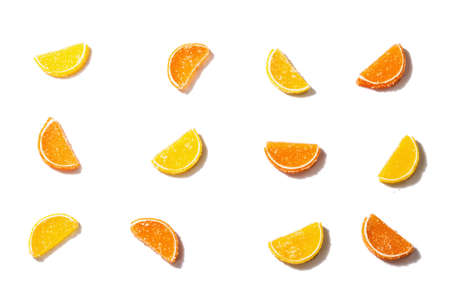 Lemon and orange marmalade isolated on white background. Jelly candies in the form of slices. Traditional sweet dessert, trendy hard light, dark shadow, flat layの写真素材