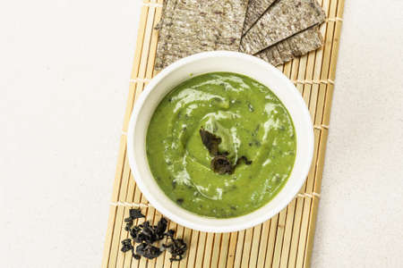 Kelp puree in a bowl. Healthy superfood from oceanic seaweed. Ingredient for smoothies, soups,...