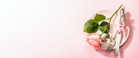 Romantic dinner table isolated on rose background. Love concept for Valentine's or Mother's day,...