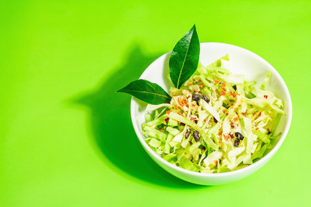 spring diet salad. Fresh vegan vitamin food. Sliced cabbage, spices, olive oil, dry berries. Healthy...