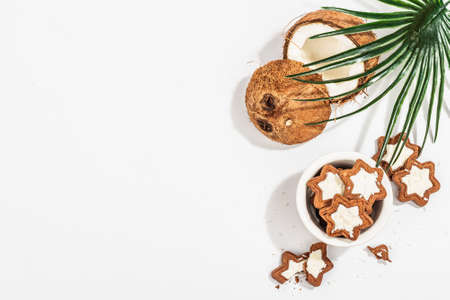 Gluten-free and lactose-free coconut cookies. Homemade healthy pastries, vegan lifestyle. A trendy hard light, dark shadow, white background, top viewの写真素材