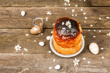 Traditional Easter cake in a rustic style. Vintage baking pot, blooming cherry plum branches. Old...