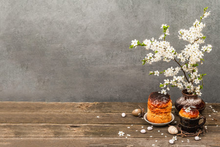 Traditional Easter cake in a rustic style. Vintage baking pot, blooming cherry plum branches. Old...