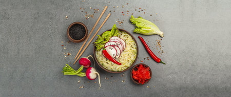 Asian noodles with vegetables and herbs. Traditional vegan Japanese soup with broth. Stone...