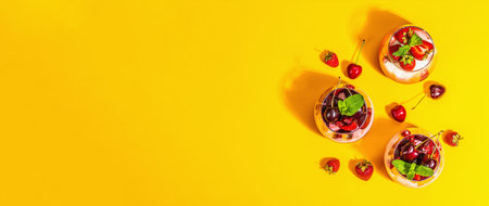 Delicious Italian dessert panna cotta with sweet cherry sauce, strawberry jam, fresh berries and...