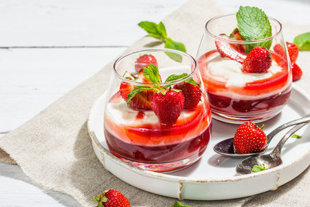 Italian dessert panna cotta in glass with strawberries. Healthy sweet food, trendy hard light, dark...