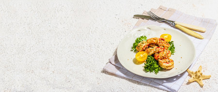 Grilled shrimp salad with lettuce, tomato cherries and spices on a plate. Fresh and healthy seafood, nautical decor. Trendy hard light, dark shadow, plaster background, banner formatの写真素材