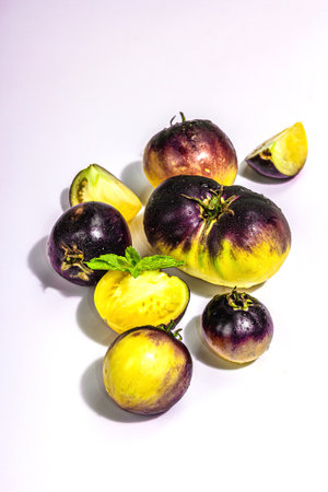 Yellow-violet Tomatoes variety Primary colors isolated on white background. Harvest of ripe vegetables, trendy hard light, dark shadowの写真素材