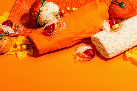 Autumn composition festive on old wooden background. Decorative pumpkin, fall leaves, berries and...