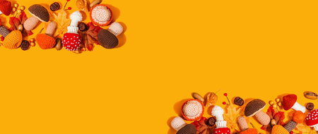 traditional autumn background. Assorted of different knitted mushrooms, handmade concept. Trendy hard light, dark shadow, flat lay, bright orange background, banner formatの写真素材