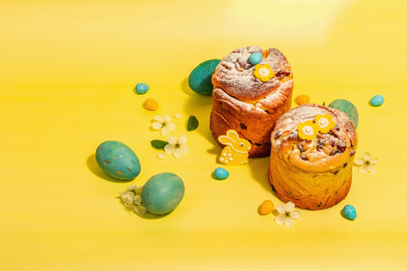 Easter cake Cruffin or sweet bread kulich and traditional painted eggs. Festive baking and cherry...