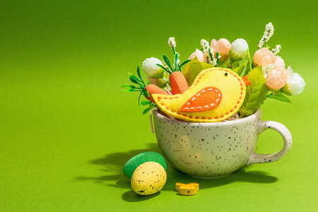 Easter bouquet in a cup. Traditional flowers, birds, decorative quail eggs. Trendy hard light, dark...