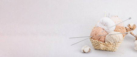 A set of pastel clew of thread for knitting in a basket. Handmade, hobby, crochet concept. Props and...