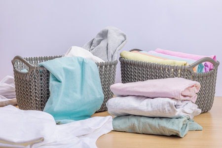 Vertical storage of clothing in the baskets. Spring closet cleaning, eco friendly style. Pastel...
