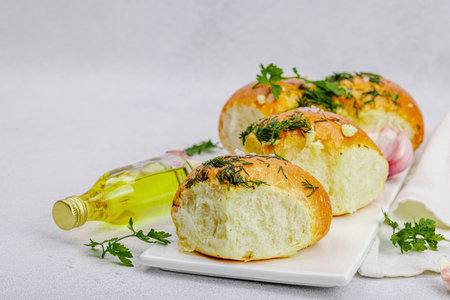 Aromatic garlic buns. Fresh baked goods, a traditional gluten-free soup snack. Parsley, spices,...