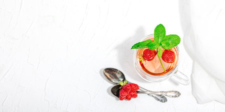 Strawberry tea concept. good morning concept. Teapot, ripe fruits, healthy beverage. Hard light, dark shadow, white background, banner formatの写真素材