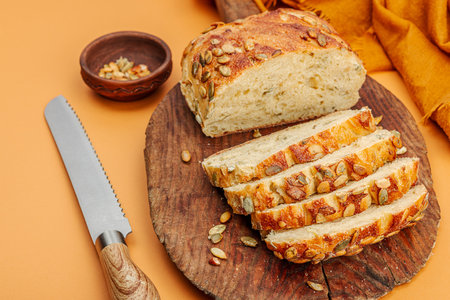 Fresh bread with pumpkin seeds. home baking concept. Autumn decor, pumpkin, fall leaves. Wooden...