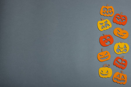 Funny Halloween background. Traditional colorful fall pumpkins with different faces. Festive flat lay, classic autumn style, top viewの写真素材