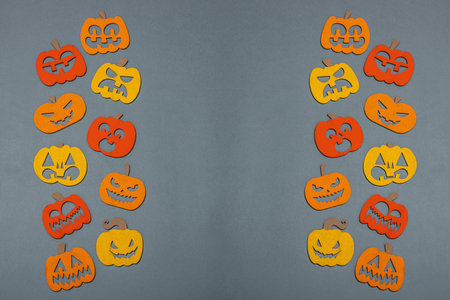 Funny Halloween background. Traditional colorful fall pumpkins with different faces. Festive flat lay, classic autumn style, top viewの写真素材