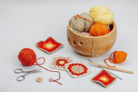 Set of clew of thread for knitting. Crocheted granny squares, handmade, autumn hobby concept. Props...