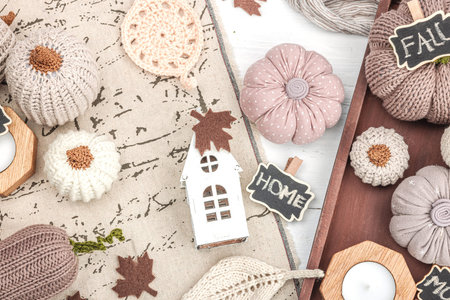 Cozy autumn mood composition. Handmade decor for home, traditional fall symbols - knitted pumpkin,...