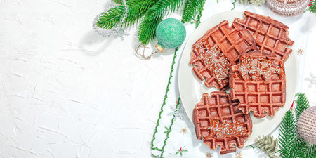 Christmas Belgian waffles with chocolate. Festive New Year dessert, traditional arrangement. Lactose free non gluten baking, trendy hard light, dark shadow. White background, flat lay, banner formatの写真素材