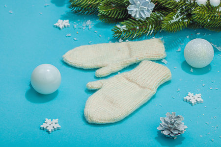Cozy winter composition. Knitted mittens, warm scarf, traditional Christmas decoration, New Year...