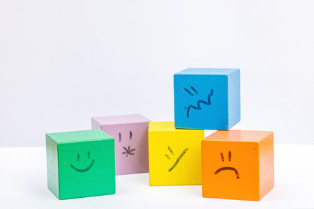 World mental health day. wooden cubes with different emotions. Feedback rating, customer review,...