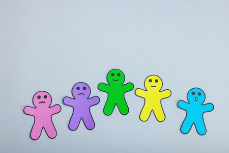 World mental health day. Paper men figures with different emotions. Feedback rating, customer review, experience, satisfaction survey or assessment concept. Neutral gray background, flat lay, top viewの写真素材
