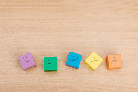 World mental health day. wooden cubes with different emotions. Feedback rating, customer review,...