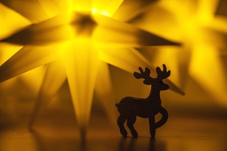 Festive greeting Christmas card. New Year holiday concept. Shiny stars, deer figure, traditional symbols. Place for text, bokeh effectの写真素材