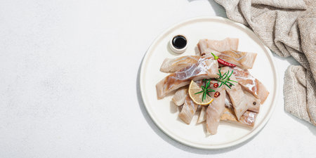 Raw pollock (Pollachius virens) fillet. Fresh fish for healthy food lifestyle. Lemon, rosemary, sea...