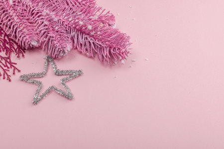 Traditional New Year composition in pink color tones. Festive decor, rosy Christmas tree branch, snowflakes. Pastel background, flat lay, copy spaceの写真素材